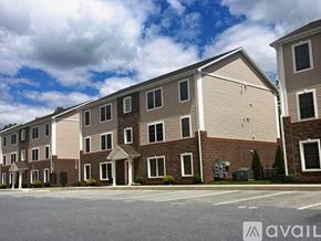 Middletown apartment for rent - A row of townhouses with a cloudy sky in the background.