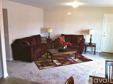 Middletown apartment for rent - A living room with a red couch and a coffee table.