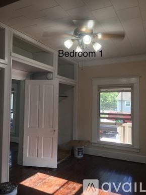 Carterville house for rent - Bedroom 1 has a window and a door.