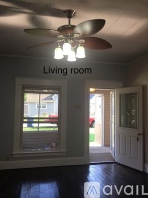 Carterville house for rent - A living room with a ceiling fan and a window.