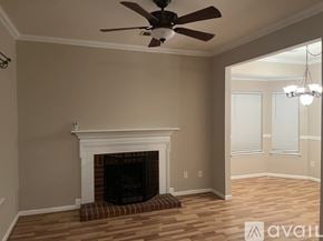 Cornelius house for rent - A room with a fireplace and a ceiling fan.