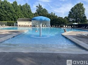 Cornelius house for rent - A large outdoor swimming pool with a waterfall feature in the middle.