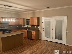 Cornelius house for rent - A kitchen with wooden floors and white walls.