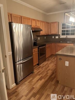 Cornelius house for rent - A kitchen with a stainless steel refrigerator and wooden cabinets.