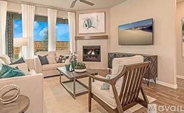 Garland house for rent - A living room with a fireplace and a painting on the wall.