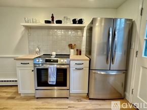 Brewster house for rent - A kitchen with a stainless steel refrigerator and oven.