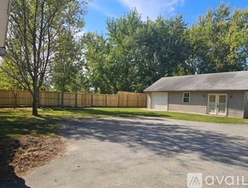 Columbia City house for rent - A kitchen with wooden cabinets and a dining table with chairs.