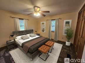 Columbia City house for rent - A bedroom with a large bed and a ceiling fan.