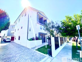 Los Angeles townhouse for rent - A white house with a black gate and a driveway.