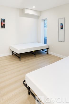 Los Angeles townhouse for rent - A bedroom with a white bed and a white mattress.