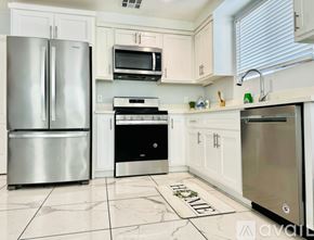 Los Angeles townhouse for rent - A kitchen with a stainless steel refrigerator, microwave, oven, and dishwasher.