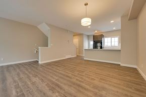 Edmonton apartment for rent - A spacious room with wooden flooring and a large window.