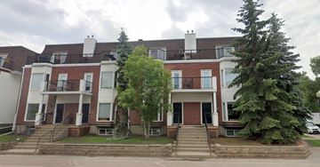 Edmonton apartment for rent - A row of townhouses with a tree in front of them.
