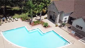 Victoria apartment for rent - a large swimming pool in front of a house