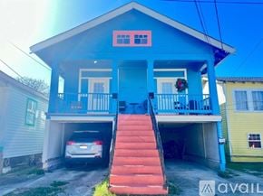New Orleans townhouse for rent - A blue house with a car in the garage.
