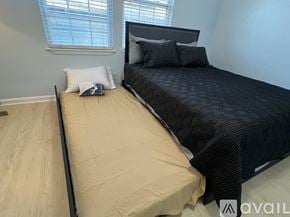 New Orleans townhouse for rent - A bedroom with a bed, pillows, and a window.