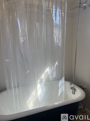 New Orleans townhouse for rent - A bathroom with a tub covered in plastic.