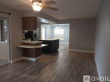 Sarasota house for rent - A kitchen area with a counter and a fan.