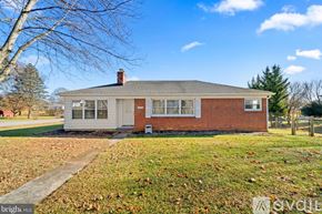 Hagerstown house for rent - A house with a red brick chimney and a grey roof.