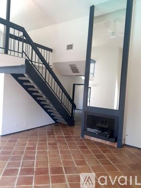 Los Angeles condo for rent - A black metal staircase with a glass balustrade.