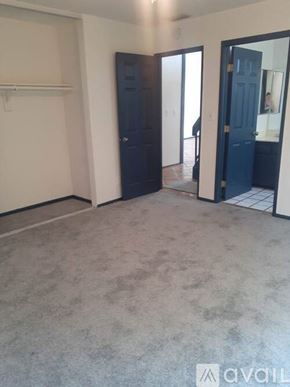 Los Angeles condo for rent - A room with a dark blue door and a white wall.