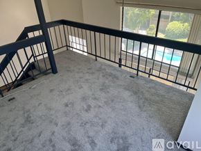 Los Angeles condo for rent - A balcony with a black railing and a grey carpet.