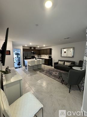 Las Vegas townhouse for rent - A modern living room with a kitchen area in the background.