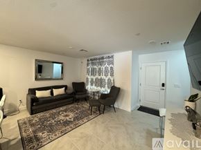 Las Vegas townhouse for rent - A living room with a couch, chair, and rug.
