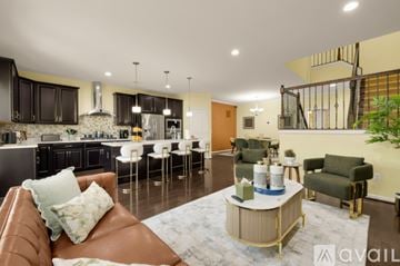 Ashburn apartment for rent - A living room with a brown leather couch and a coffee table.