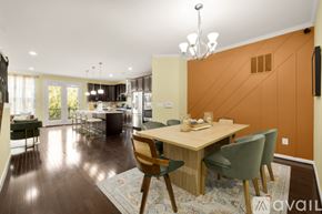 Ashburn apartment for rent - A modern dining room with a wooden table and chairs.