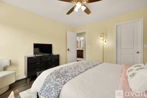 Ashburn apartment for rent - A bedroom with a bed, dresser, and television.