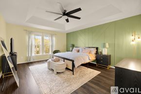 Ashburn apartment for rent - A bedroom with a bed, nightstand, and chair.