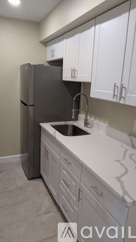 St. Petersburg apartment for rent - A kitchen with a sink and a refrigerator.