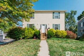 Ypsilanti house for rent - A house with a white door and a small porch with a step up to it.