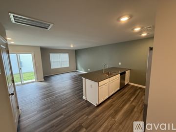 Greer townhouse for rent - A kitchen with white cabinets and a wooden floor.