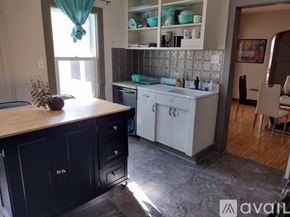 Oshkosh apartment for rent - A kitchen with black cabinets and a wooden countertop.