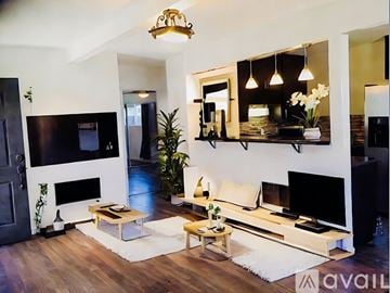 San Diego house for rent - A living room with a fireplace and a tv on the wall.