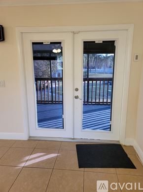 Boynton Beach condo for rent - A white door with a black mat in front of it.