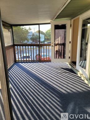 Boynton Beach condo for rent - A balcony with a striped carpet and a view of the street.