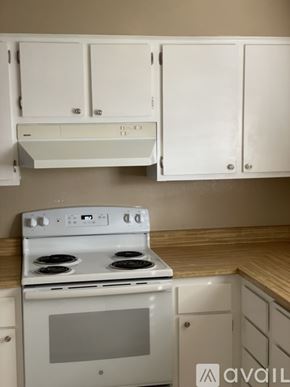 Benicia apartment for rent - A white oven with a stove top sits under a cabinet.