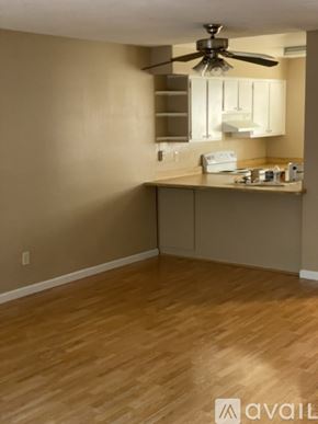 Benicia apartment for rent - A kitchen area with a fan and wooden flooring.