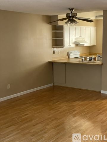 Benicia apartment for rent - A kitchen area with a fan and wooden flooring.