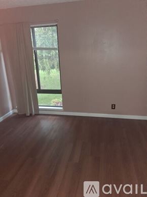 Benicia apartment for rent - A concrete pathway leads through a grassy area with trees on either side.