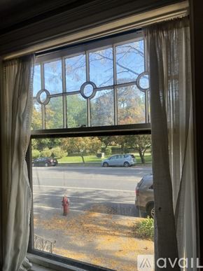 Albany apartment for rent - A room with a fireplace and a window with curtains.