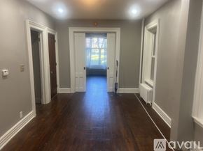 Albany apartment for rent - A room with wooden floors and white trim.