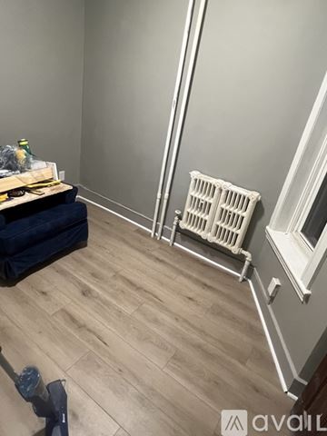 Albany apartment for rent - A kitchen with white appliances and green cabinets.