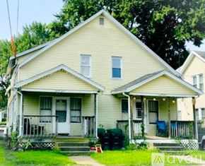 Chicopee apartment for rent - A two-story house with a front porch and a small front yard.