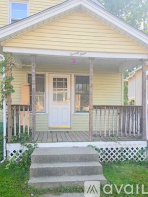 Chicopee apartment for rent - A yellow house with a white door and a porch.