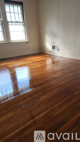 Chicopee apartment for rent - A room with wooden floors and a window.