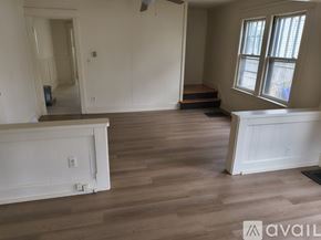 Chicopee apartment for rent - A room with wooden flooring and white walls.